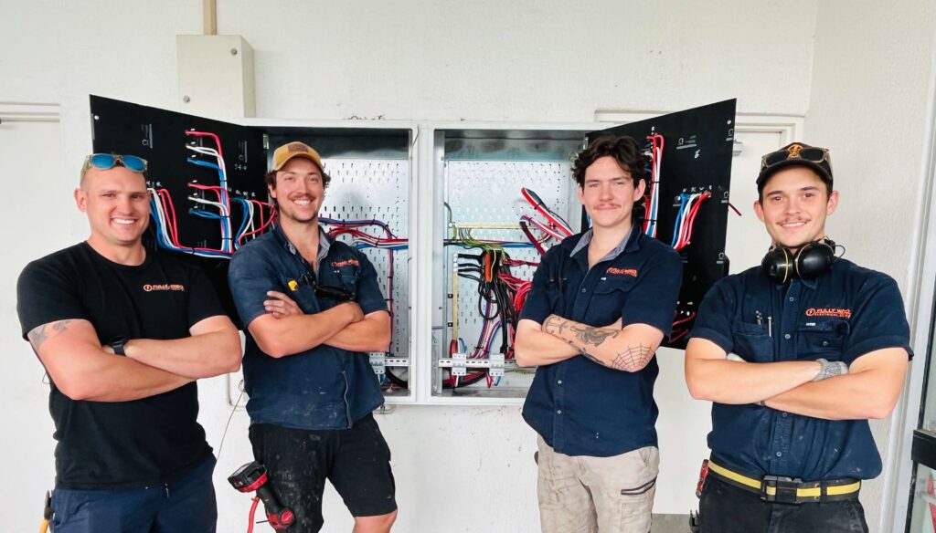 Three Fully Wired electricians after completing a shopping complex switchboard upgrade in Kingston