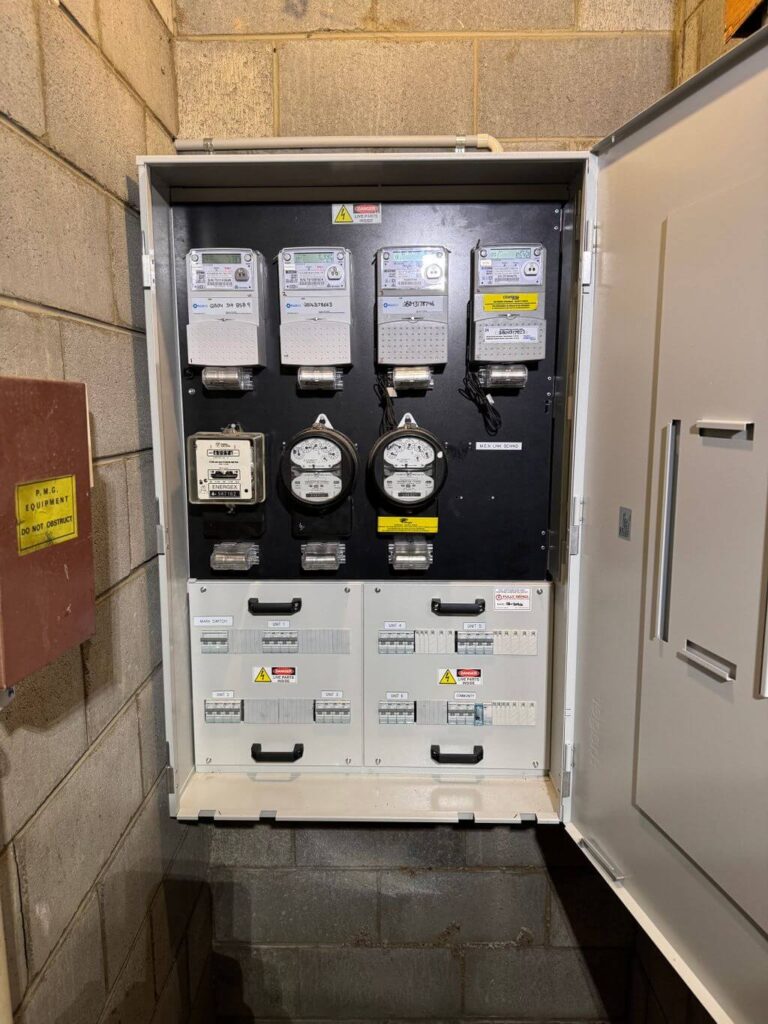Upgraded switchboard with circuit breakers and meters inside a Brisbane unit complex meter room