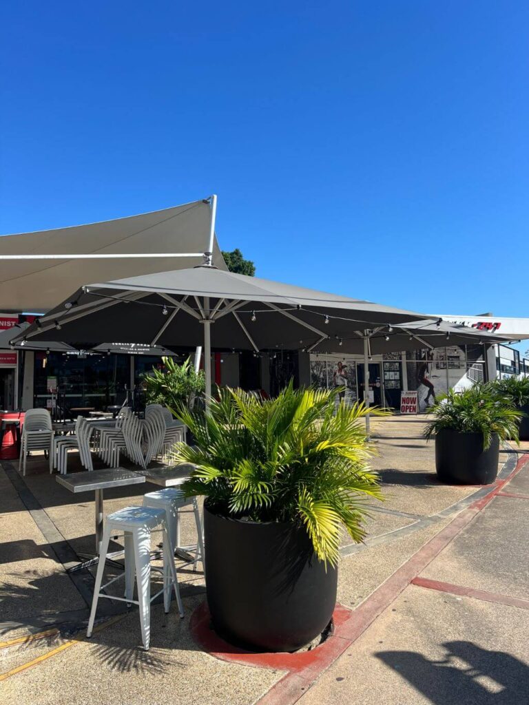 Festoon lighting under umbrellas at an outdoor eatery in Milton