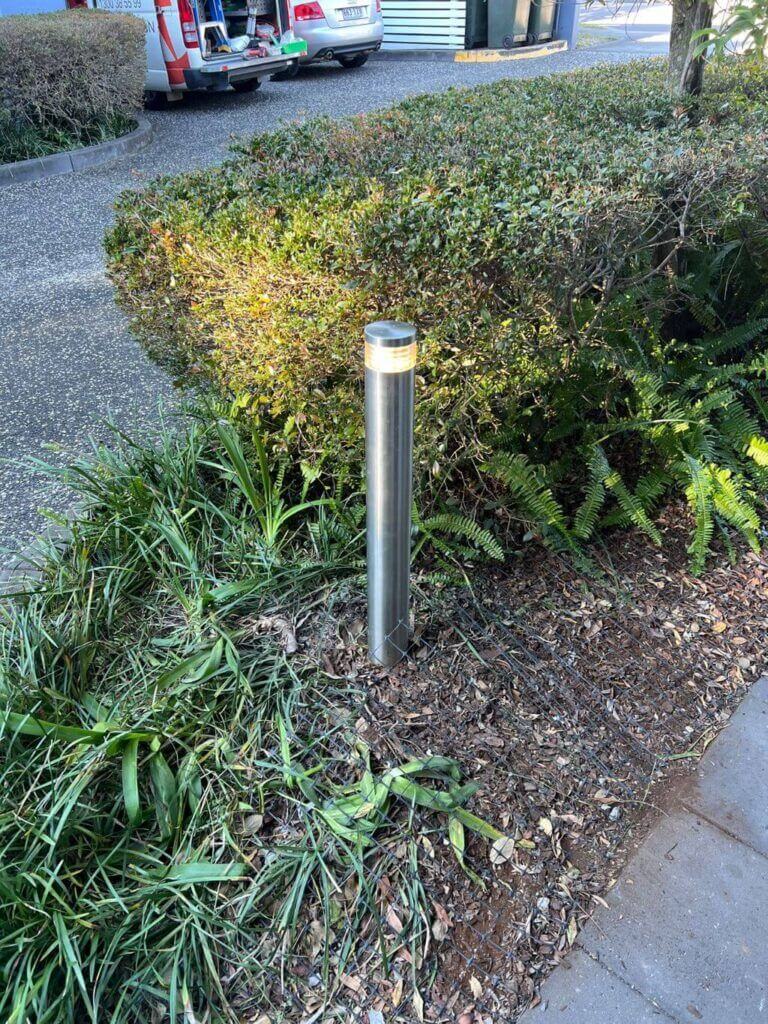New modern bollard light installed in a garden bed at a Morningside complex