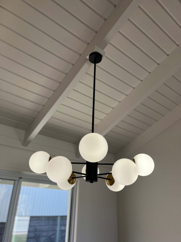 Feature pendant lights hanging in a bright renovated Kenmore living area
