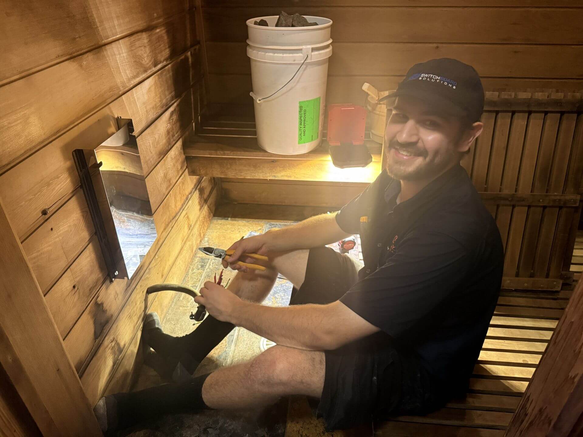 Electrician installing sauna heater