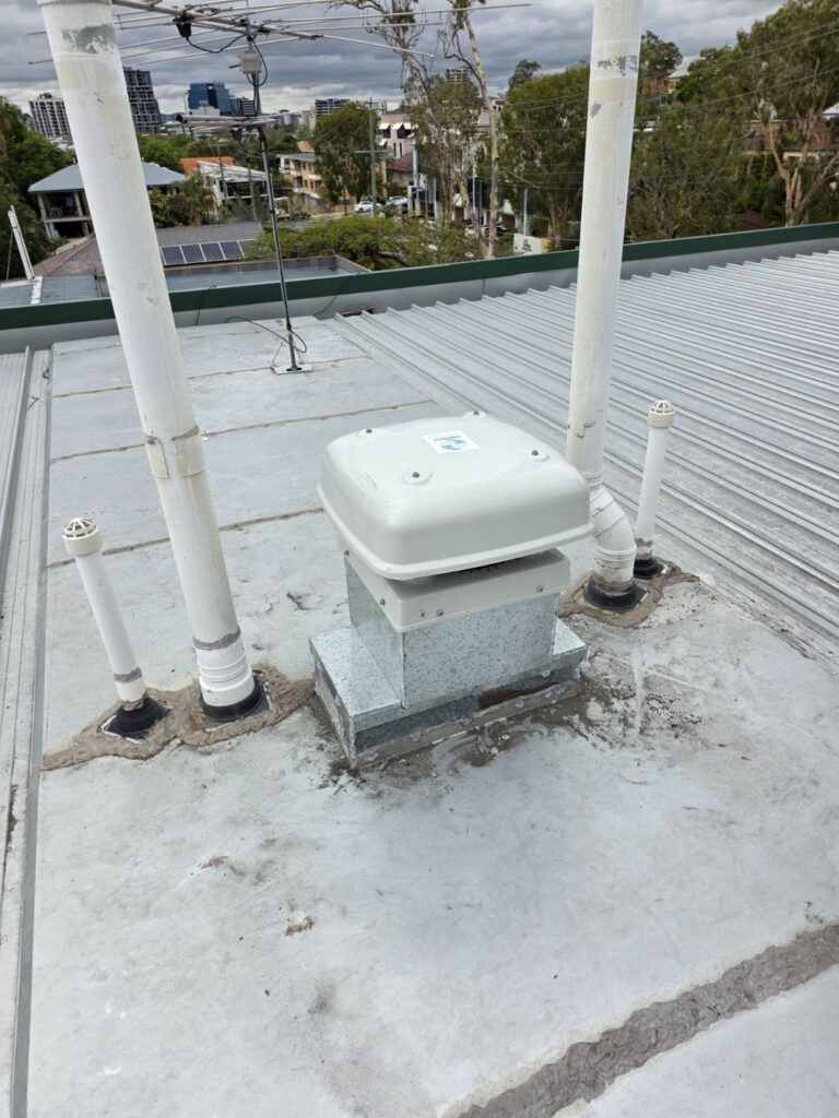 New high-efficiency rooftop exhaust fan installed on a Toowong unit complex