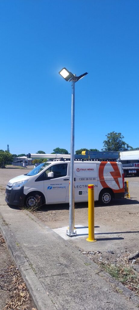 Fully Wired van beside a replaced street light pole at a Kallangur body corporate