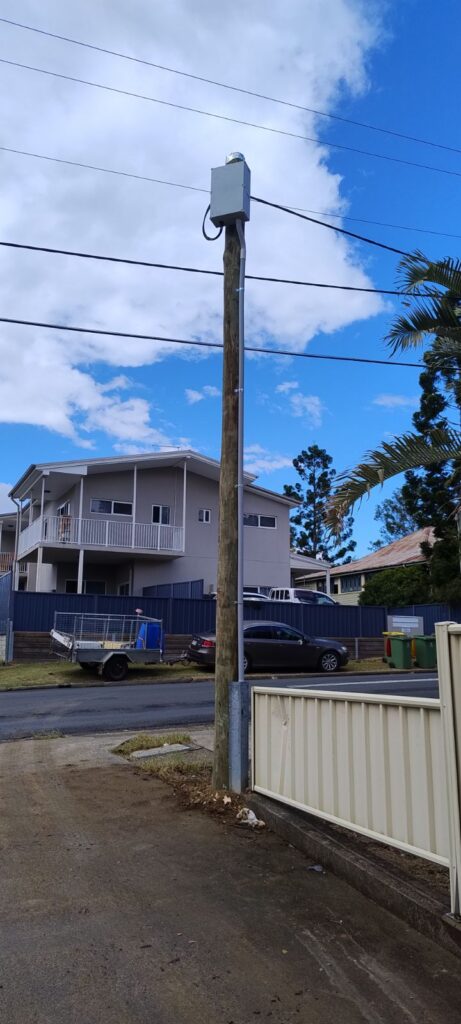 New property pole carrying the overhead service line to a Booval home after replacement by Fully Wired